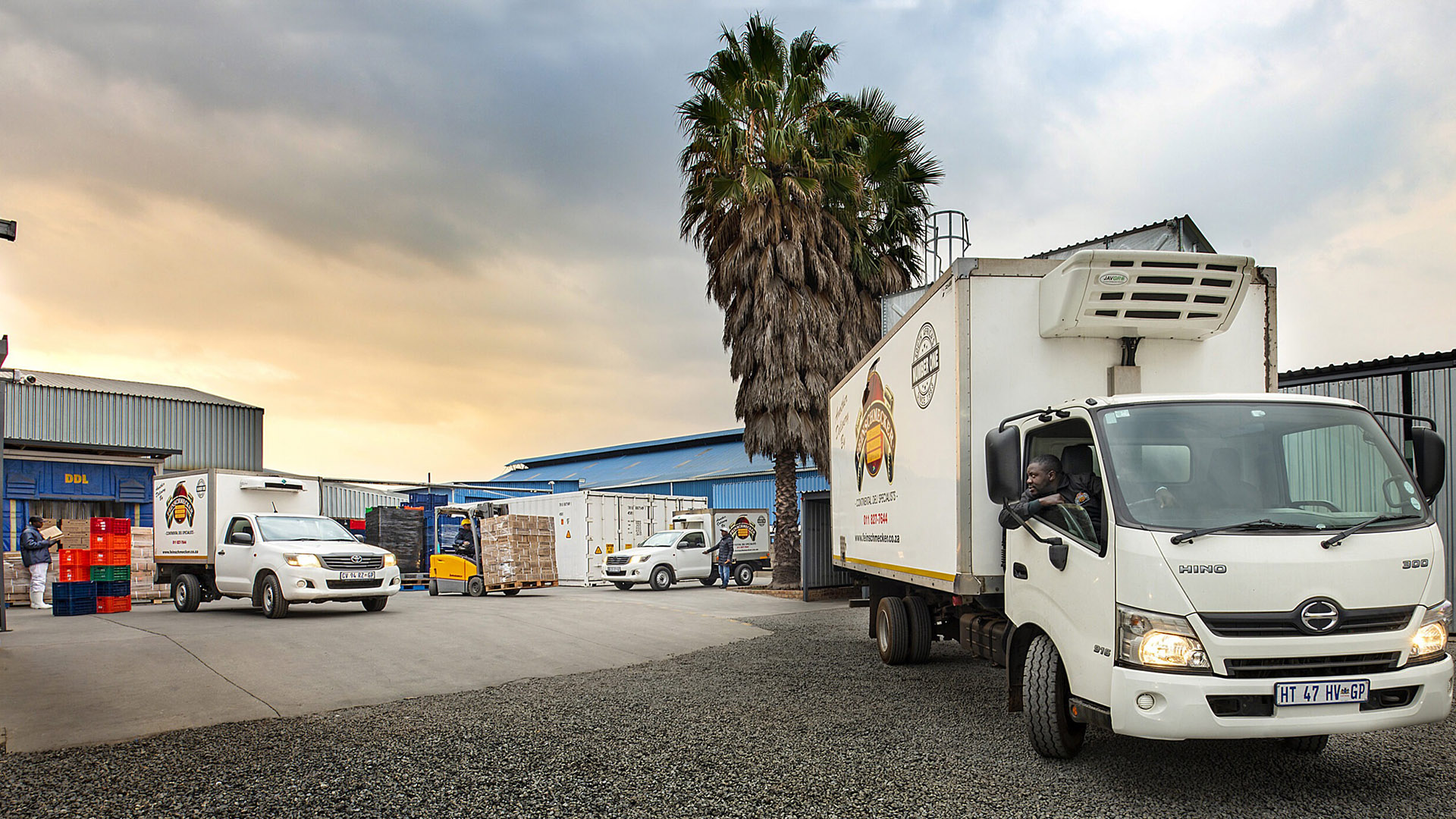 Feinschmecker delivery trucks at dusk